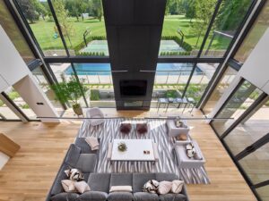 dramatic contemporary living space with double height glass walls